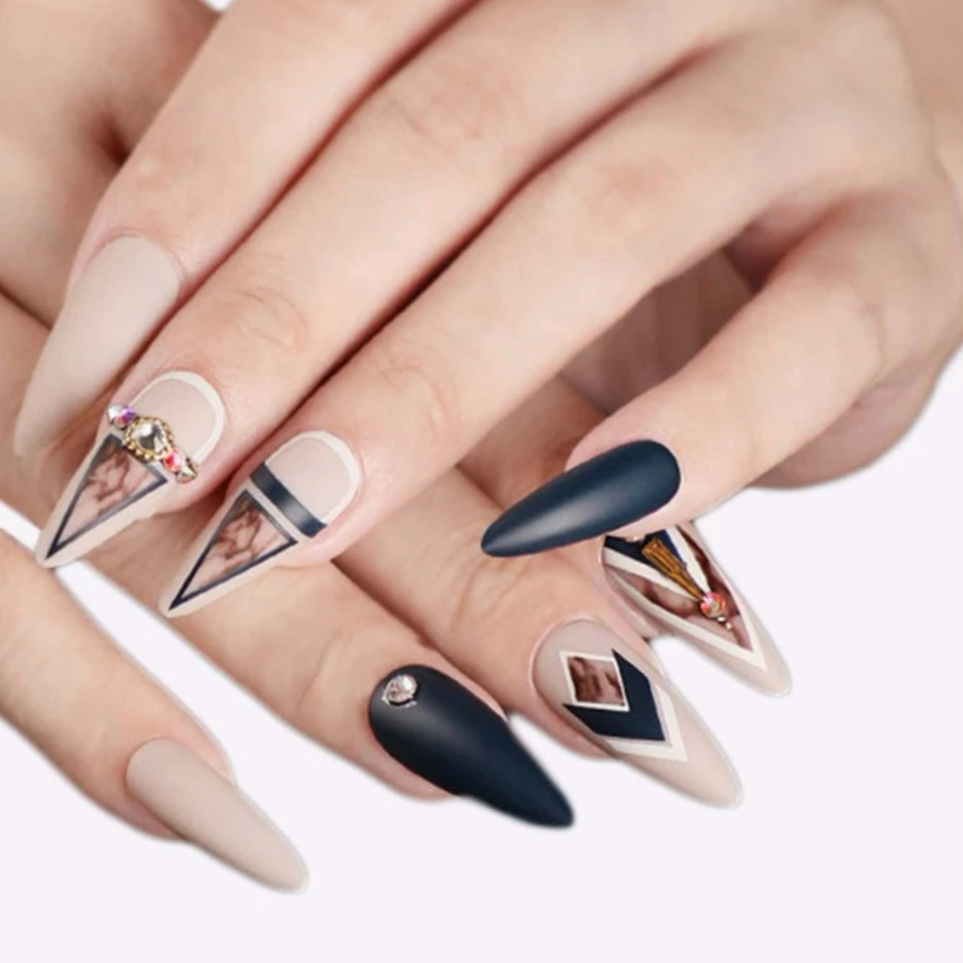 black and nude almond shaped press on nails with a marble design and unique gems