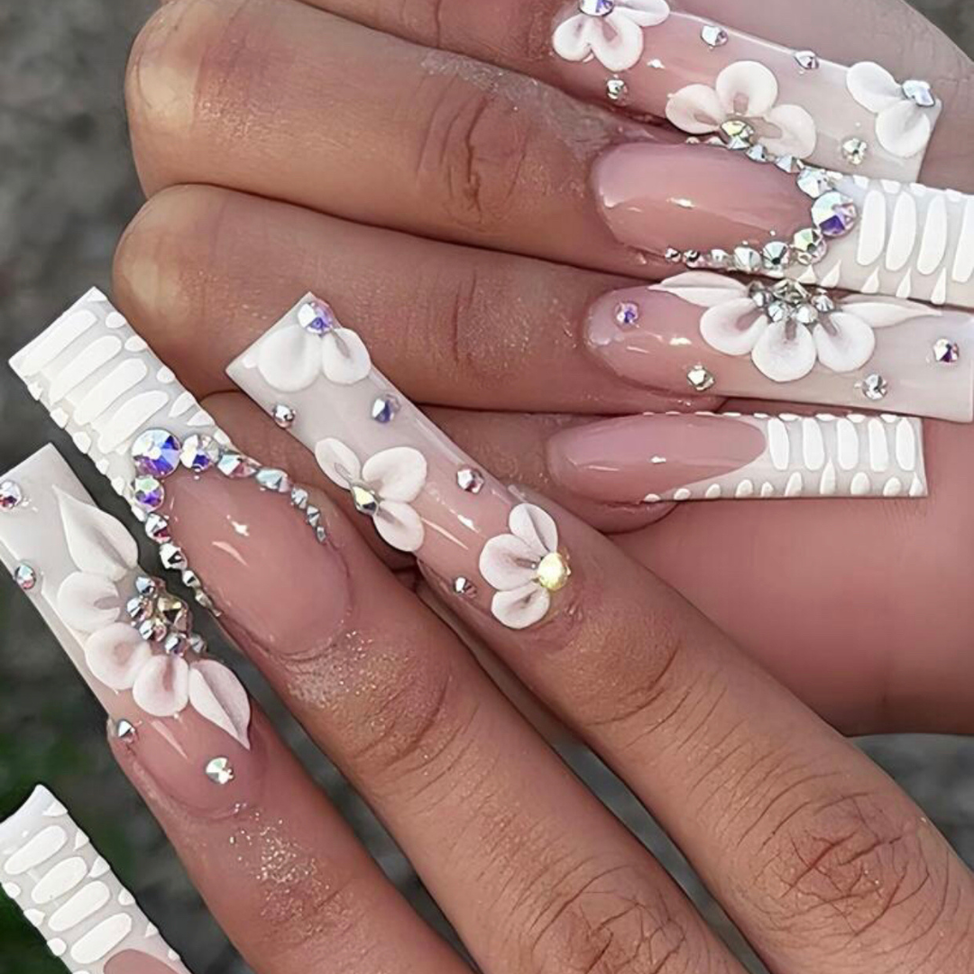false press on nails with a french tip designed to look like a crocodile as well as gems and flower designs all over